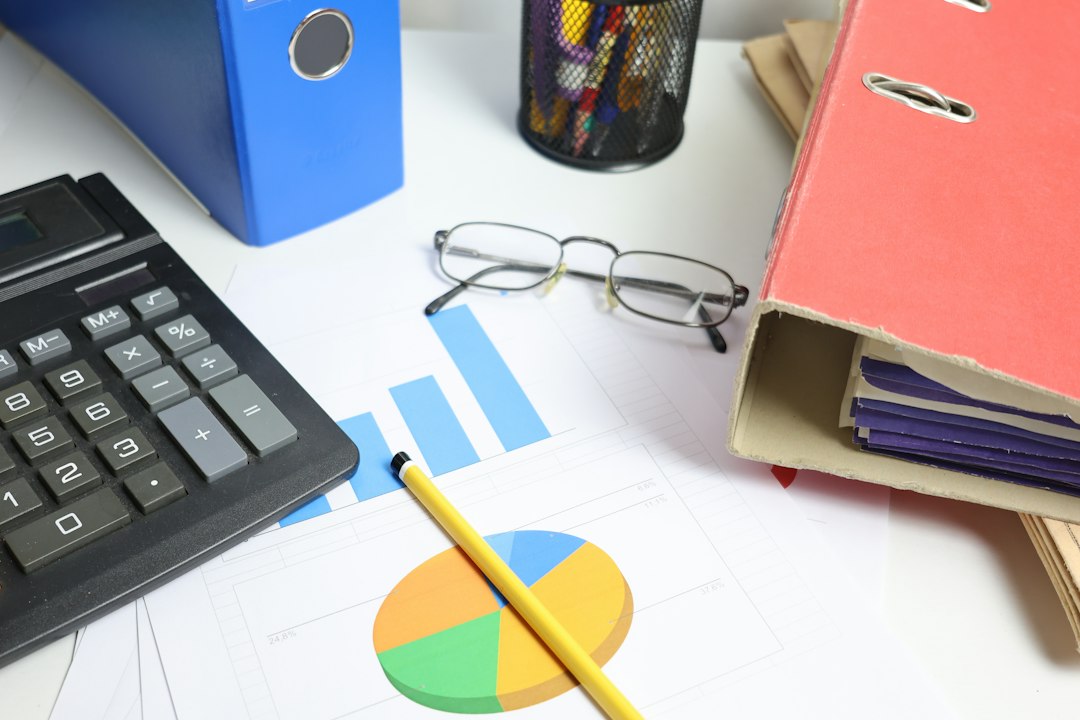Sleek, modern calculator sits on a clean desk beside neat stacks of coins, representing the meticulous process of calculat...