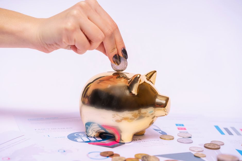 Minimalist photo of a broken ceramic piggy bank lying on a clean surface next to a set of house keys, symbolizing the loss...